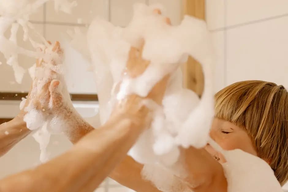 A joyful child playing with bubbles in the bath, emphasizing fun and clean hygiene.